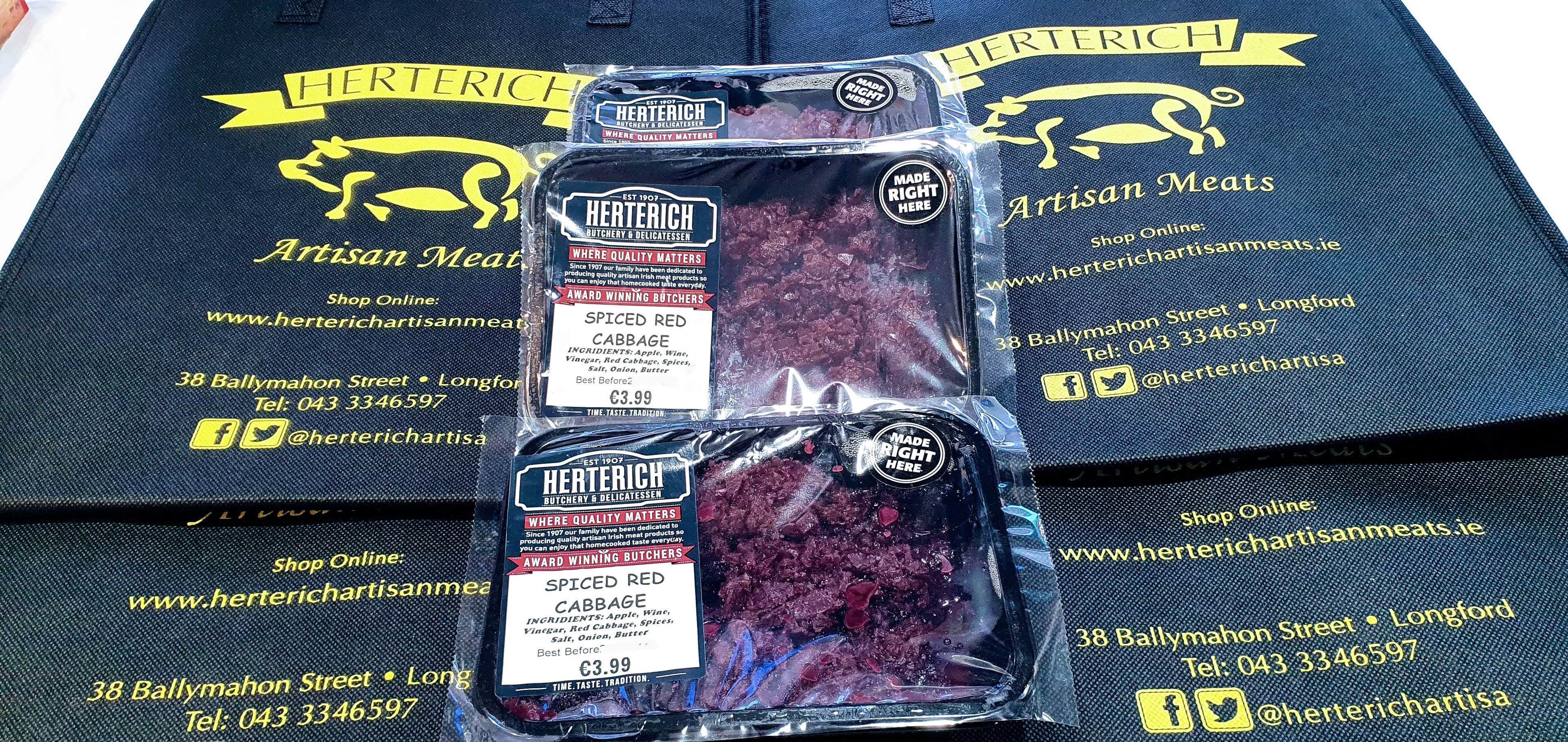 Packaged spiced red cabbage side dish in plastic wrapping with the brand 'Hertel's Artisan Meats' visible.