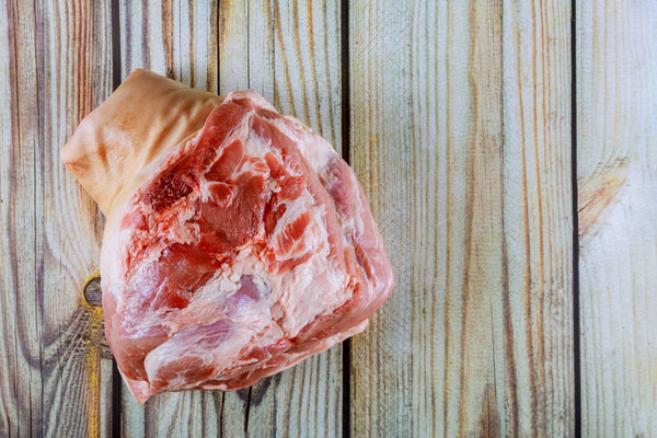 Herterich's Raw Ham Hock or Shank meat on a wooden surface