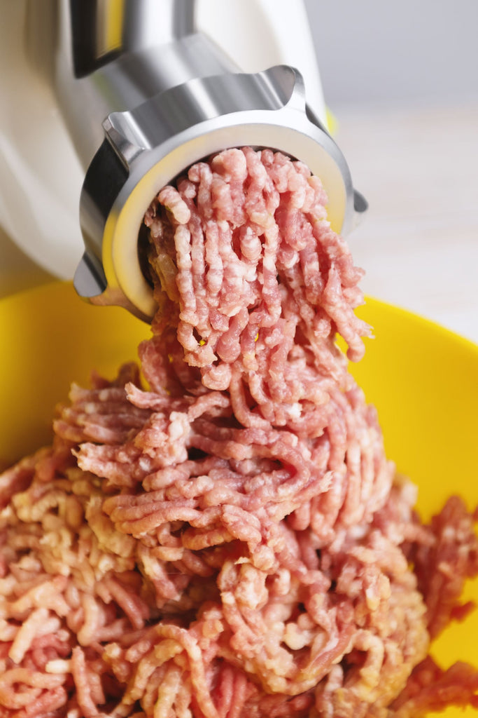 Freshly Ground Pork Mince (~500g) coming out of a grinder, ideal for sausages and pies.