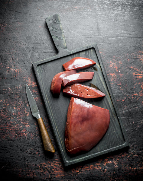 Fresh 500g Sliced Pork Liver pieces on a cutting board with a knife, ready for cooking.