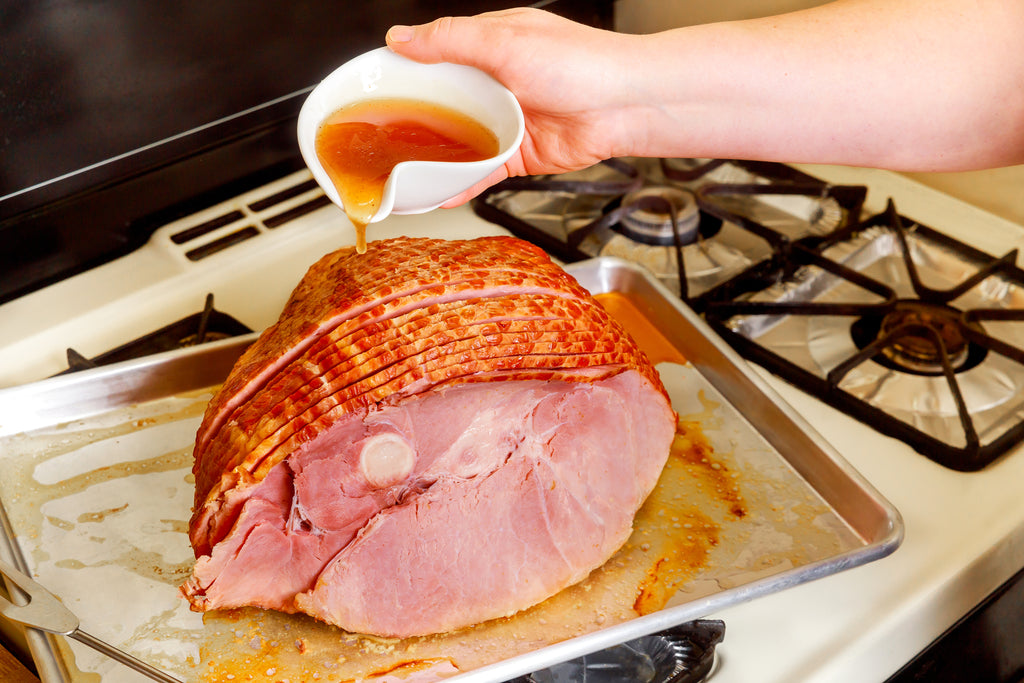 Cooked Traditional Cured Honey Roast Ham on the Bone (7-8kg), with a golden honey and mustard seed glaze.