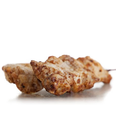 A skewered chicken kebab coated with sweet chili sauce.