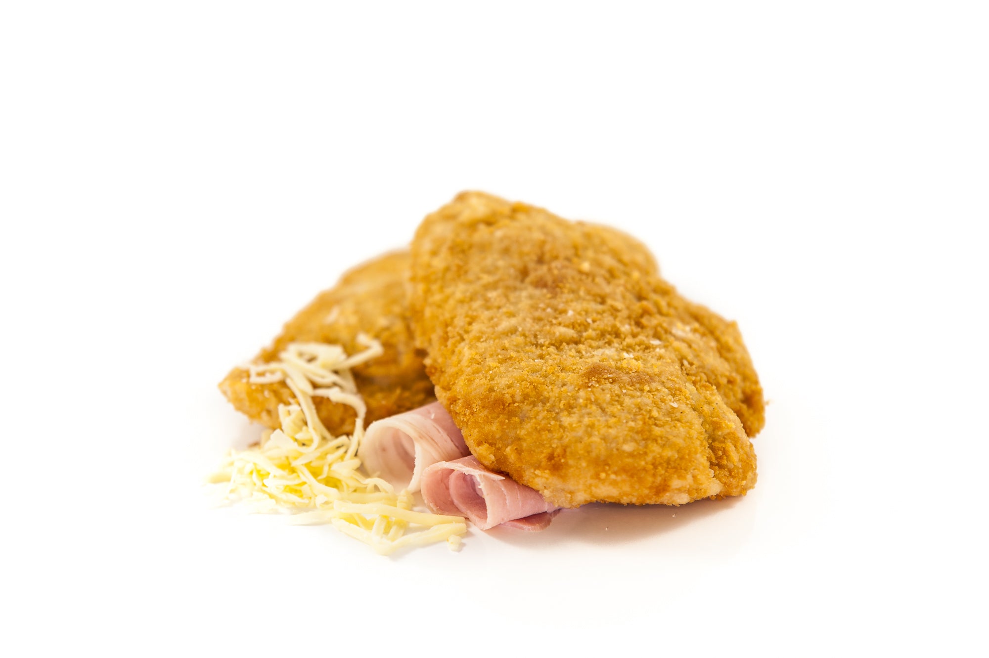 Two raw Chicken Cordon Bleu portions with a golden crumb, filled with Irish chicken, ham, and cheddar cheese.