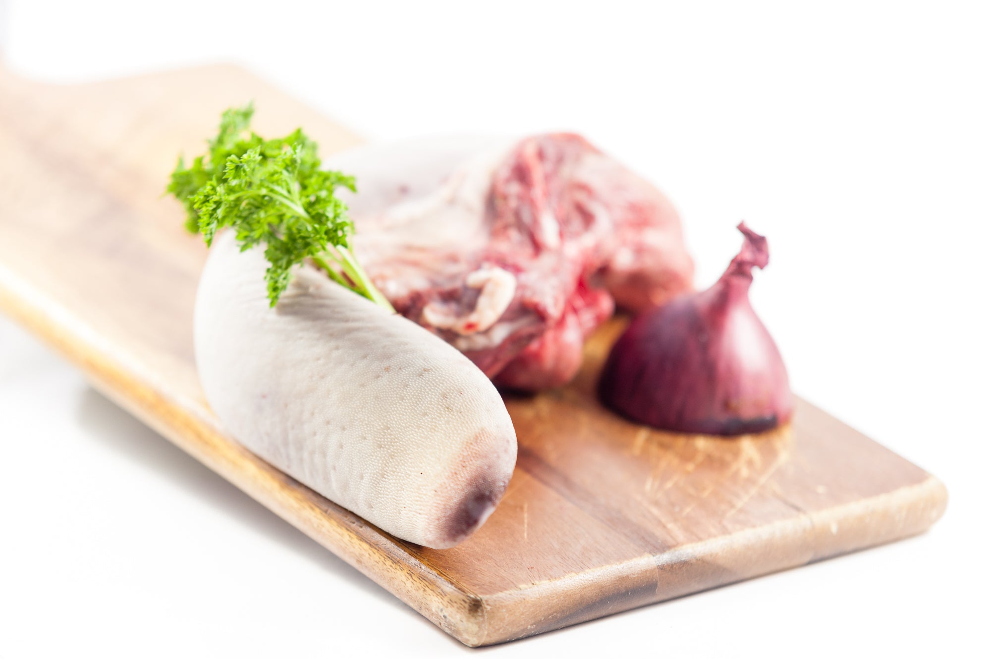 Raw Ox Tongue (Beef Tongue), a traditional and versatile cut of Irish beef on a wooden platter.